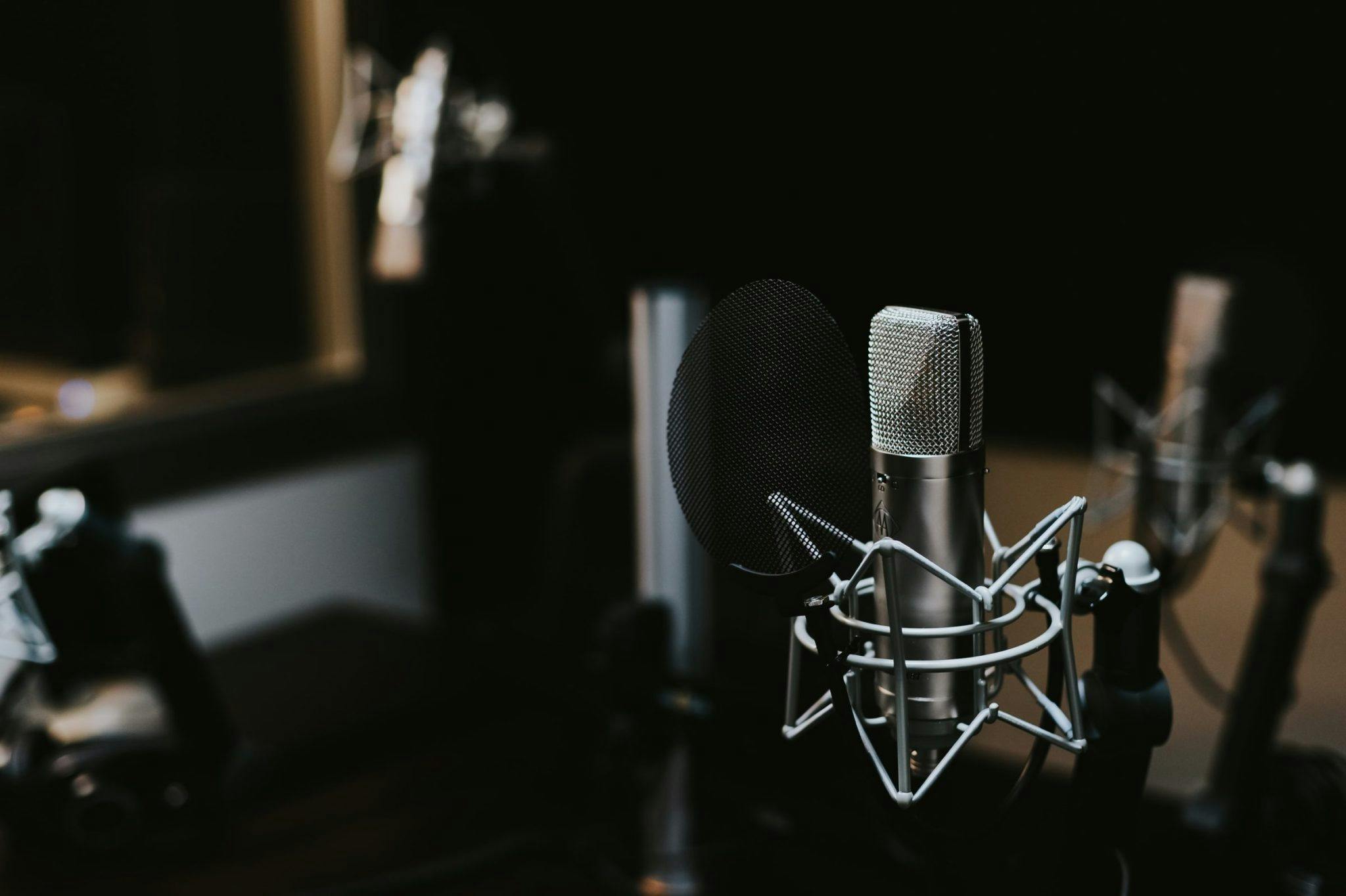 podcast microphone on a table in a dark room
