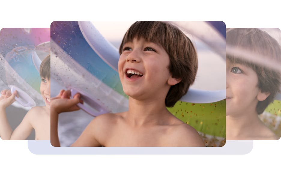 boy laughing and holding a pool float