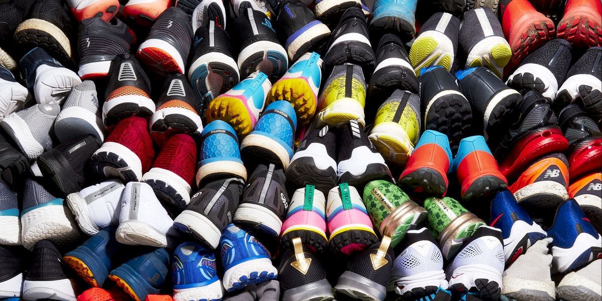 A photo of lots of sports shoes piled ontop of each other.