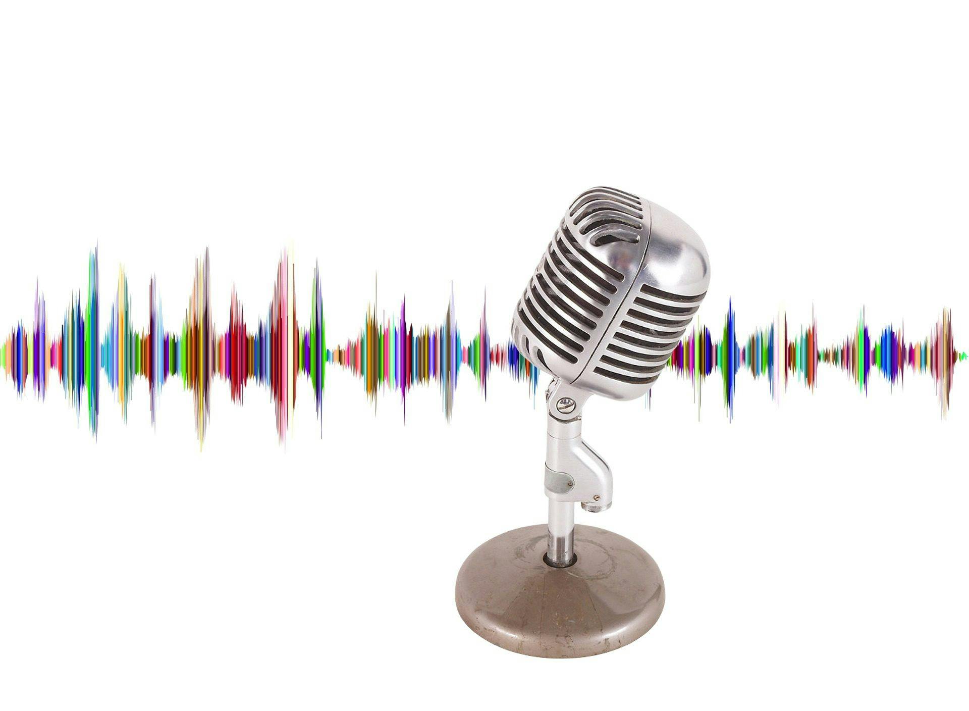 silver microphone in front of colorful sound waves