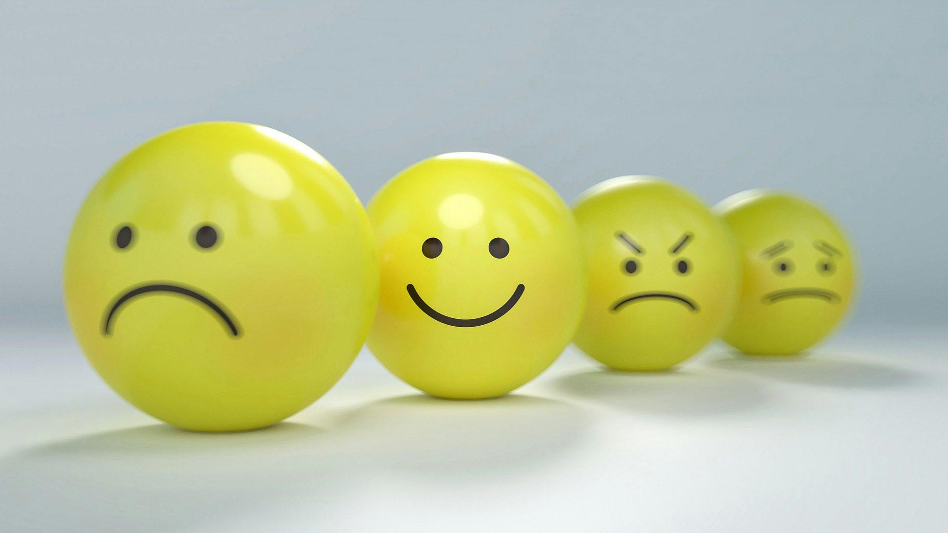 4 yellow balls displaying different emotions