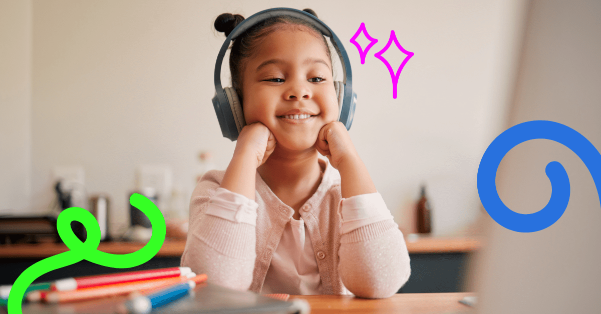 A little girl in a pink top wearing headphones