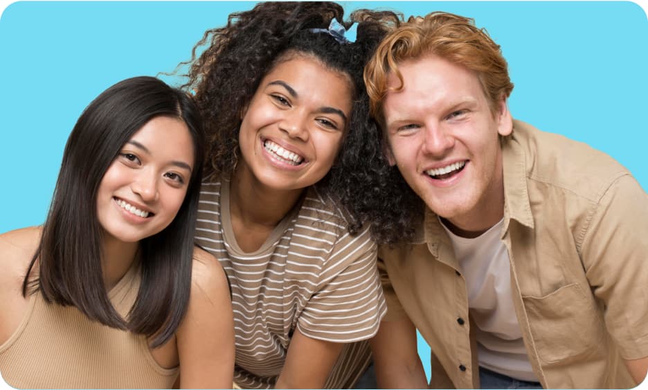  three people standing next to each other smiling at the camera