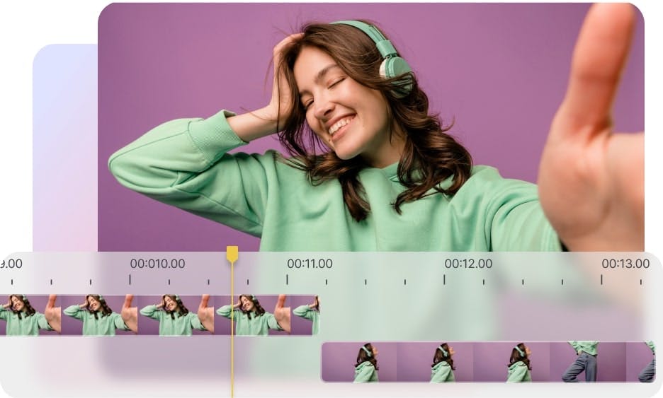 woman wearing green headphones and a green sweater holding the camera with a video editing timeline shown at the bottom